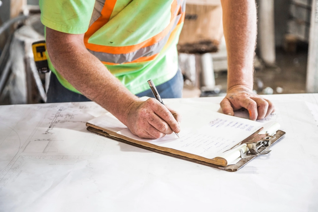 construction worker goes plans site